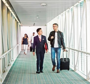 A male marhaba representative assisting a passenger