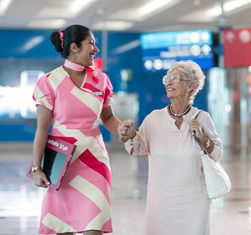 A marhaba representative assisting an elderly passenger