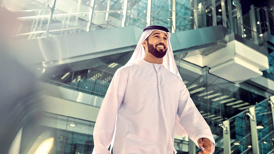 a smiling local man walking through the airport