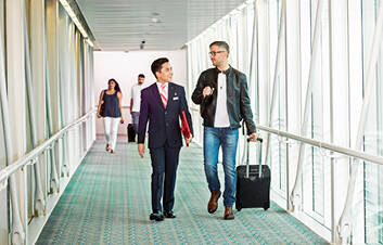 A man walking through the airport with a marhaba representative