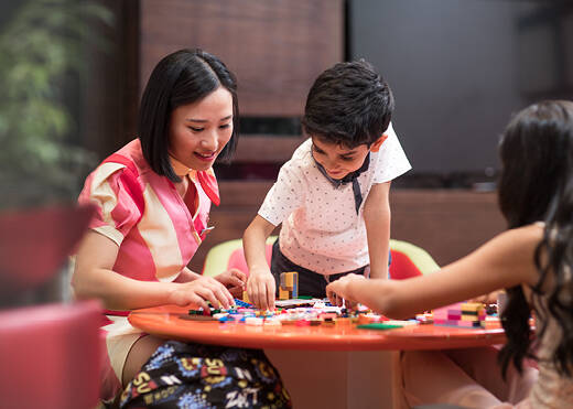 a marhaba representative playing with children inside a marhaba lounge