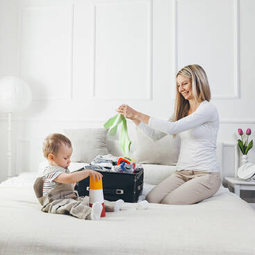 mother preparing babys luggage
